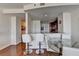 Dining area with glass table and white leather chairs adjacent to the kitchen at 3338 Ne Peachtree Ne Rd # 1102, Atlanta, GA 30326