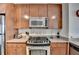 Kitchen with stainless steel appliances, granite countertops, and wood cabinets at 3338 Ne Peachtree Ne Rd # 1102, Atlanta, GA 30326