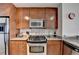 Kitchen featuring stainless steel appliances, granite countertops, and wood cabinetry at 3338 Ne Peachtree Ne Rd # 1102, Atlanta, GA 30326
