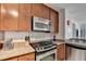 Modern kitchen with granite countertops, stainless steel appliances, and breakfast bar at 3338 Ne Peachtree Ne Rd # 1102, Atlanta, GA 30326