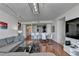 Open living area with hardwood floors, large sectional sofa, and view of dining area and kitchen at 3338 Ne Peachtree Ne Rd # 1102, Atlanta, GA 30326