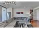 Living room featuring hardwood floors, a gray sectional sofa, glass-top coffee table, and artwork at 3338 Ne Peachtree Ne Rd # 1102, Atlanta, GA 30326