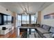 Living area with large sectional, hardwood floors, and access to balcony at 3338 Ne Peachtree Ne Rd # 1102, Atlanta, GA 30326
