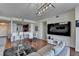 Spacious living room with hardwood floors, a large sectional sofa, dining area, and large TV at 3338 Ne Peachtree Ne Rd # 1102, Atlanta, GA 30326