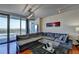 Living room with sectional sofa, glass coffee table, and large windows with a scenic balcony view at 3338 Ne Peachtree Ne Rd # 1102, Atlanta, GA 30326