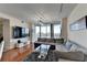 Living room showcasing a large sectional sofa, glass coffee table, wall-mounted TV, and scenic views at 3338 Ne Peachtree Ne Rd # 1102, Atlanta, GA 30326