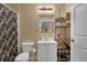 Basement bathroom with shower, toilet, sink, and storage at 102 Twilight Overlook, Canton, GA 30114