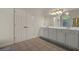 Double vanity bathroom with large mirror and built-in cabinets at 102 Twilight Overlook, Canton, GA 30114