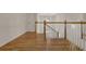 Upstairs hallway with hardwood floors and railing at 102 Twilight Overlook, Canton, GA 30114