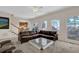 Sunken living room with a sectional sofa and access to a deck at 102 Twilight Overlook, Canton, GA 30114