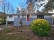 Ranch home with gray brick, red door, and landscaped yard at 2652 Winthrop Rd, Atlanta, GA 30337