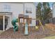 Wooden playset with slide, climbing wall, and swings at 355 Arbor Creek Trl, Roswell, GA 30076