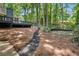 Wooded backyard with a pathway leading to a deck at 2231 Deep Creek Dr, Marietta, GA 30068