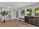 Spacious entryway with herringbone wood floors, artwork, and a door to the main living area at 495 Valley Ne Ln, Atlanta, GA 30328