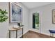 Bright foyer with herringbone wood floors, a console table, and a glass front door at 495 Valley Ne Ln, Atlanta, GA 30328