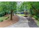 Driveway leading up to a blue house nestled among trees at 495 Valley Ne Ln, Atlanta, GA 30328