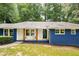 Front view of a blue brick house with white trim and a covered entryway at 495 Valley Ne Ln, Atlanta, GA 30328