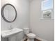 Clean, modern bathroom with pedestal sink and updated fixtures at 6949 Melody Dr, Buford, GA 30518