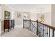 Upstairs hallway with wood and wrought iron railing overlooking the foyer at 1235 Summerfield Dr, Cumming, GA 30040