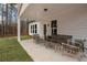 Relaxing covered back porch with comfortable outdoor seating and view of the backyard at 6101 Marigold Way, Atlanta, GA 30349