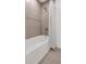 Modern bathroom with a shower and bathtub, decorated with tiled walls at 6101 Marigold Way, Atlanta, GA 30349