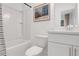 Clean bathroom with white fixtures, bathtub, and artwork at 6101 Marigold Way, Atlanta, GA 30349