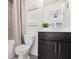 Bathroom with a shower, toilet, and dark wood vanity and tiled floors at 6101 Marigold Way, Atlanta, GA 30349