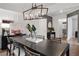 Dining room with modern chandelier, large table, and view into hallway at 6101 Marigold Way, Atlanta, GA 30349