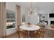 Dining area with round table and modern light fixture, adjacent to the living area at 6101 Marigold Way, Atlanta, GA 30349