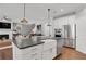Open-concept kitchen with island, farmhouse sink, and stainless steel appliances at 6101 Marigold Way, Atlanta, GA 30349