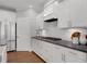 Bright, modern kitchen featuring white cabinets, dark countertops, and stainless steel appliances at 6101 Marigold Way, Atlanta, GA 30349