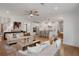 Open plan living room and kitchen with hardwood floors, fireplace, and neutral decor at 6101 Marigold Way, Atlanta, GA 30349