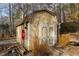 Tan shed with double doors in backyard setting at 2410 Emerald Dr, Loganville, GA 30052