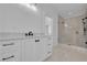 Modern bathroom with a large walk-in shower and white cabinetry at 2860 Caney Park Way, Cumming, GA 30041