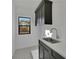 Laundry room with dark cabinetry, quartz countertops, and patterned flooring at 2860 Caney Park Way, Cumming, GA 30041