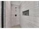 Clean shower with gray tile and built-in shelf at 4193 Wingfoot Ct, Decatur, GA 30035