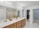 Modern bathroom with double vanity, large mirror, and separate shower and toilet areas at 6097 Marigold Way, Atlanta, GA 30349