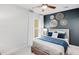 Cozy bedroom with carpeted flooring, accent wall, and ceiling fan at 6097 Marigold Way, Atlanta, GA 30349