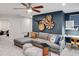 Spacious bonus room with a sectional sofa, wall decor, and small desk workspace at 6097 Marigold Way, Atlanta, GA 30349