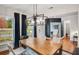 Bright dining room with large windows, hardwood floors, and a view of the home office at 6097 Marigold Way, Atlanta, GA 30349