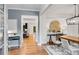 Dining room with shiplap walls, modern light fixture, and view into the living area at 6097 Marigold Way, Atlanta, GA 30349