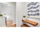 Entryway with a floating wood shelf, bench, and a view of the home office at 6097 Marigold Way, Atlanta, GA 30349