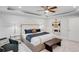 Serene main bedroom with shiplap accent wall, plush bedding, and a cozy sitting area at 6097 Marigold Way, Atlanta, GA 30349