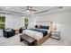 Relaxing main bedroom featuring shiplap walls, a comfortable bed, and stylish accents at 6097 Marigold Way, Atlanta, GA 30349