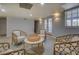 Basement living area with wicker furniture and French doors at 1103 Etowah Valley Ln, Woodstock, GA 30189