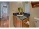 Simple bathroom with dark granite countertop and wooden vanity at 1103 Etowah Valley Ln, Woodstock, GA 30189