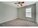Spacious bedroom with neutral gray walls, plush carpet, and ceiling fan at 1103 Etowah Valley Ln, Woodstock, GA 30189