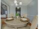 Dining room with a round table set for four and hardwood floors at 1103 Etowah Valley Ln, Woodstock, GA 30189