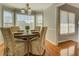 Dining area with a round table, chairs, a bay window, and hardwood floors at 1103 Etowah Valley Ln, Woodstock, GA 30189