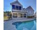 Backyard view of home with screened-in porch, deck, and pool at 1103 Etowah Valley Ln, Woodstock, GA 30189
